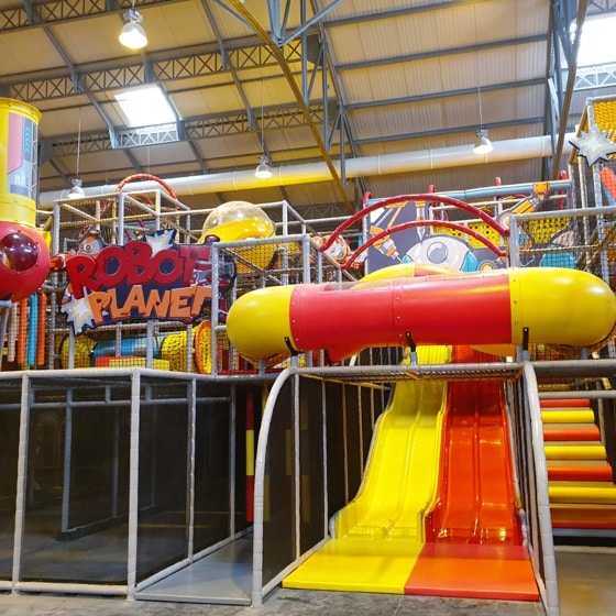 orange and yellow wave slide in a playground (robot planet)