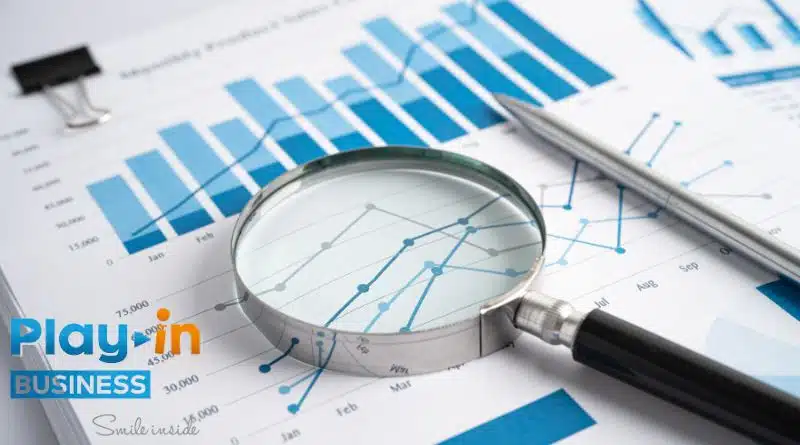market study with a chart, pen, and a magnifying glass