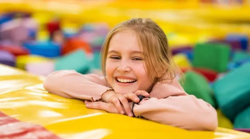 happy child in a foam cube pit