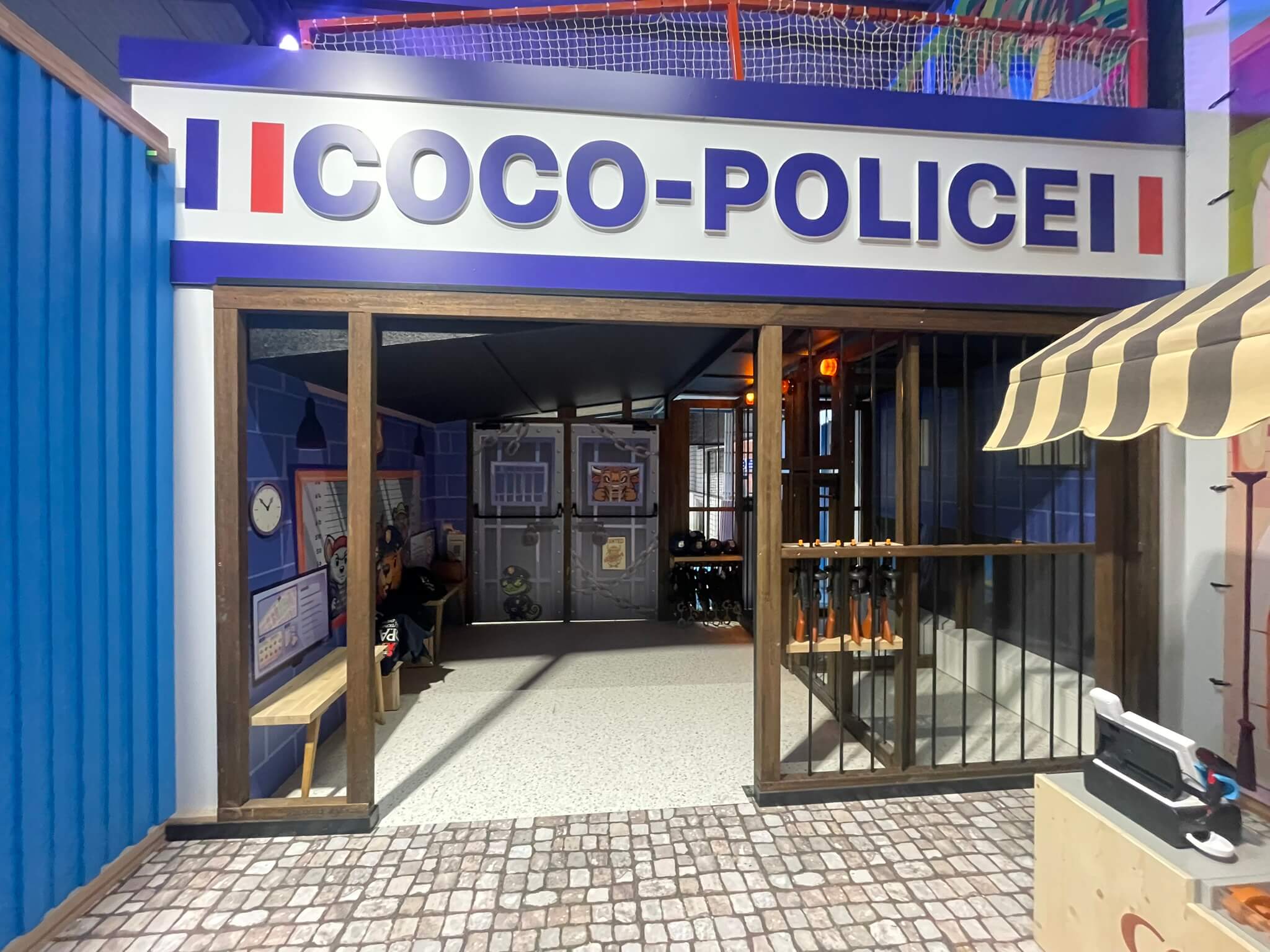 Jeu d'imitation commissariat de police avec cellule et décors pour parc de loisirs indoor.
